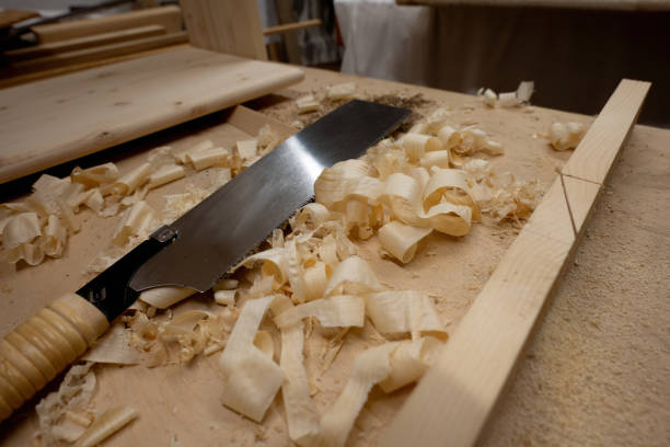 Hand saw with wooden chips.