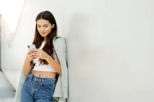 istock Beautiful woman holding smartphone using mobile app messaging in social media. Technology concept 1699223208