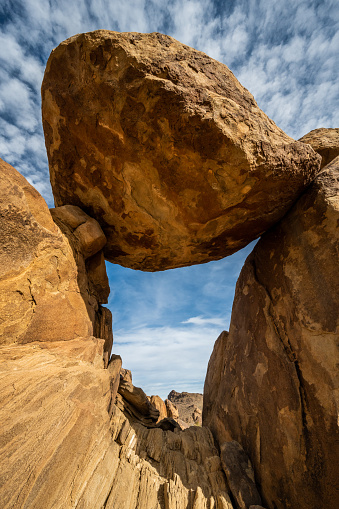 Balanced Rock Precariously Perched Over Narrow Tunnel in Grapevine Hills