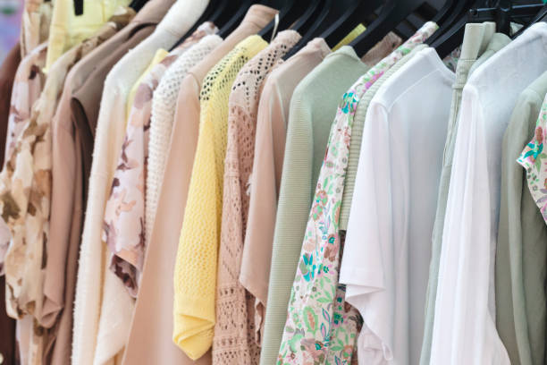 istock Multicolor family clothes on hangers in store 1699248043