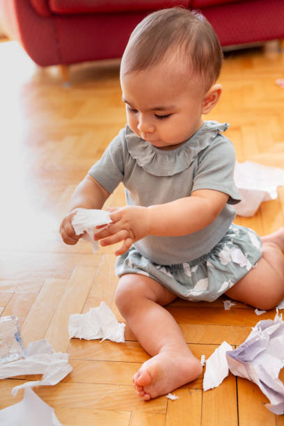 istock Baby busy tearing paper 1699248612