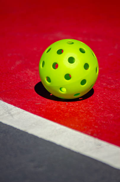 istock green pickleball ball on a red court 1699249165