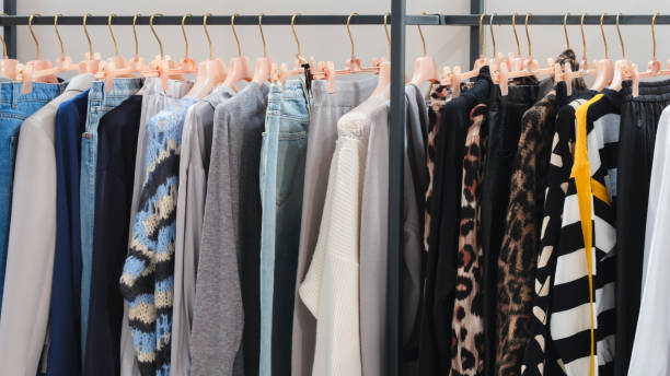istock Multicolor family clothes on hangers in store 1699271445