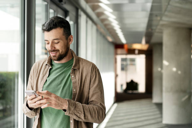 istock Confident latin businessman holding mobile phone checking email, communication online in office 1699272014