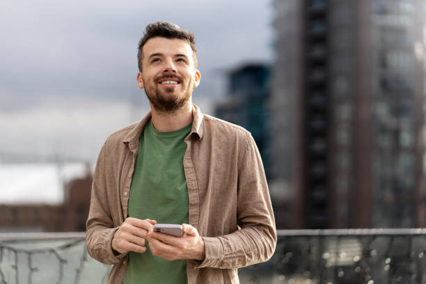 istock Smiling middle aged hispanic man holding smartphone using mobile app shopping online, ordering food 1699272023