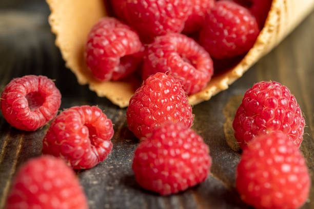 istock Ripe red raspberries in a crispy waffle cone 1699297288