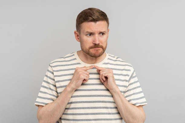 istock Embarrassed middle age man senses of shame look away think about trouble isolated studio background 1699325264
