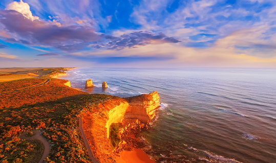 Panoramic aerial view of Twelve Apostles National Park at sunset from high viewpoint in the sky.