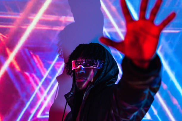 istock Man raising hand wearing futuristic goggles 1699367187