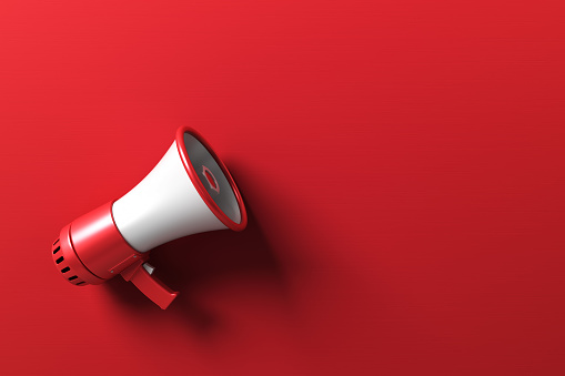Red Electric Megaphone on Red Background Stock Photo