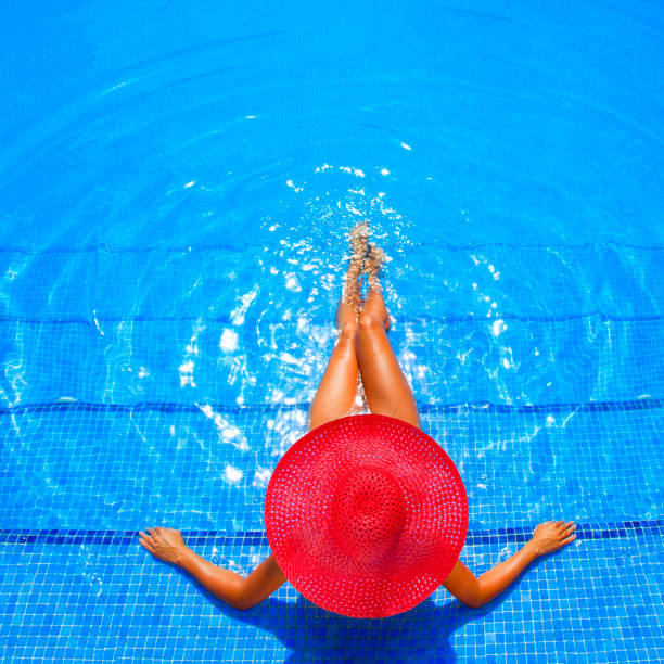 woman relaxing in resort swimming pool