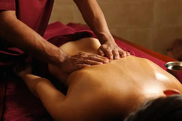 A portrait of a caucasian enjoying an ayuverdic massage.