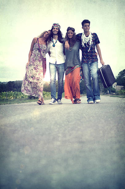istock Hippies walking on the road. 1970s style. 169940756