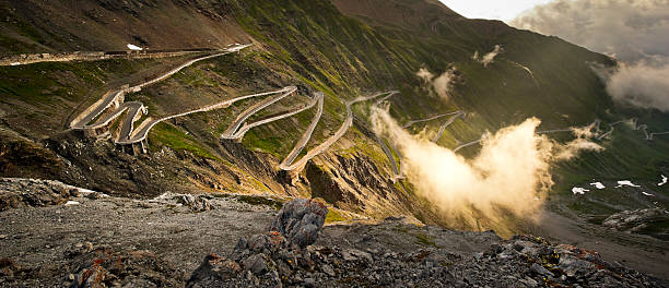 The Stelvio road Stilfser Joch - Passo dello Stelvio in the clouds at dawn. steep photos stock pictures, royalty-free photos & images