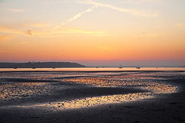 Springtime Lowtide Sunset at Sandbanks Harbour, Poole, UK, exposing the Cockle Beds with views towards Brownsea Island