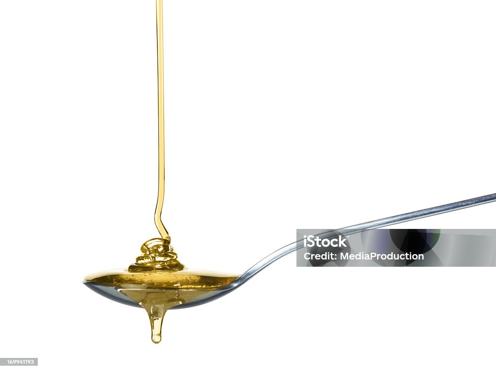Verter en una cuchara de miel - Foto de stock de Miel libre de derechos