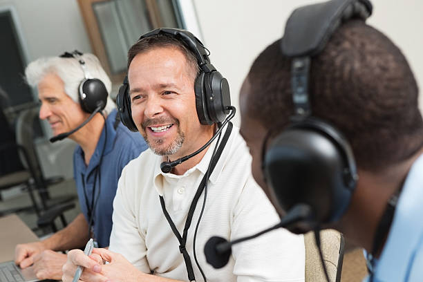 istock Smiling sportscasters discussing game in the media box 169941282
