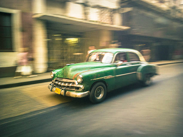 Old American car speeding on a street in Havana, Cuba.