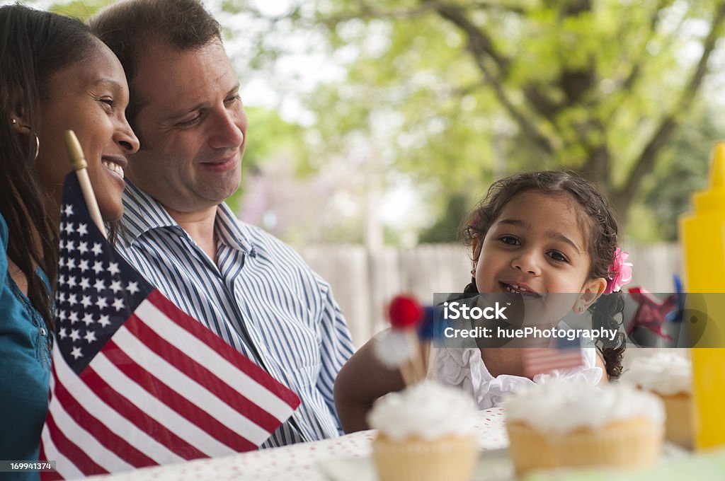 Family 4th of July Picnic Mixed-race family enjoying a 4th of July (independence day) picnic in their backyard. Fourth of July Stock Photo