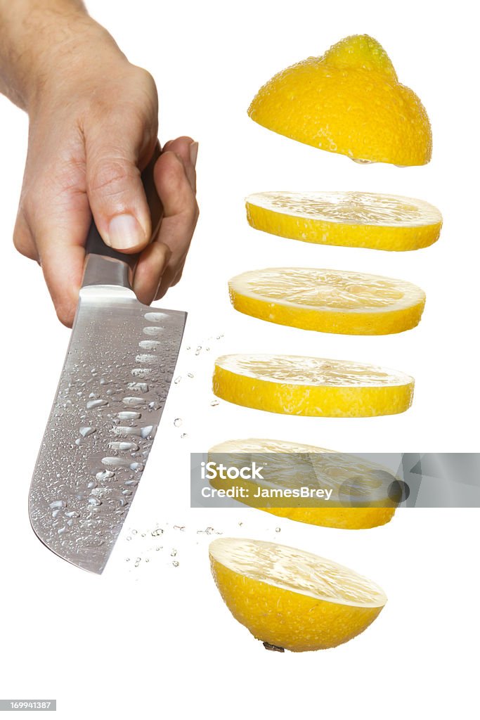 Chef's Knife Slicing Lemon in Mid-Air  Lemon - Fruit Stock Photo