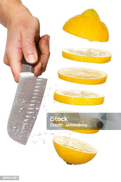 Chefs Knife Slicing Lemon In Midair Stock Photo - Download Image Now - Lemon - Fruit, Slice of Food, Cutting