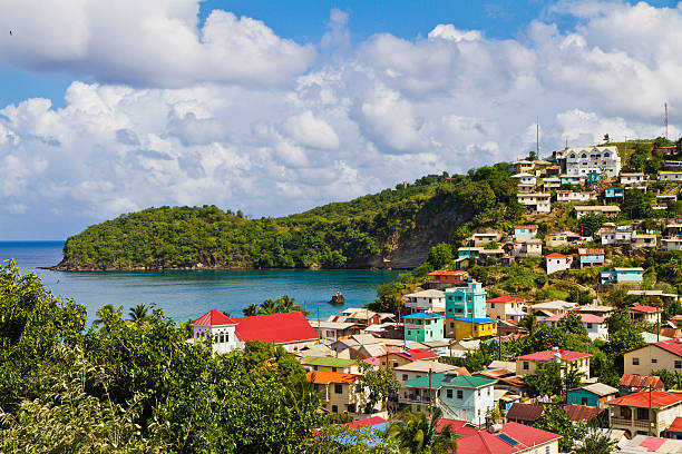A aerial view of the island of St Lucia Canaries is a quaint fishing village nestled on the beautiful and scenic winding West Coast Road, built after the 1960s, before the construction of which, the village was accessible only by sea. Its colorful houses overlook a quiet bay. fishing village photos stock pictures, royalty-free photos & images