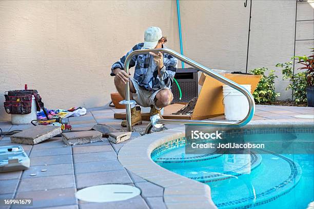 Safety Installing A Pool Hand Rail Stock Photo - Download Image Now - Swimming Pool, Construction Industry, Building Contractor