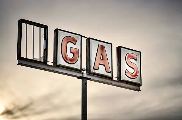 An abandoned gas station neon sign