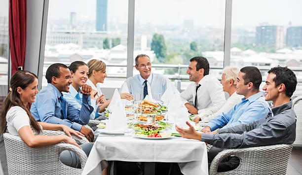 Businesspeople on lunch Lunch break. Group of successful businesspeople sitting and eating.    business lunch stock pictures, royalty-free photos & images