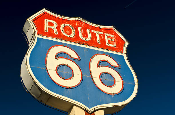 Route 66 Americana Red and Blue Neon Highway Sign Historic Route 66 Shield Shaped Neon Sign Along the old route route 66 sign old road stock pictures, royalty-free photos & images