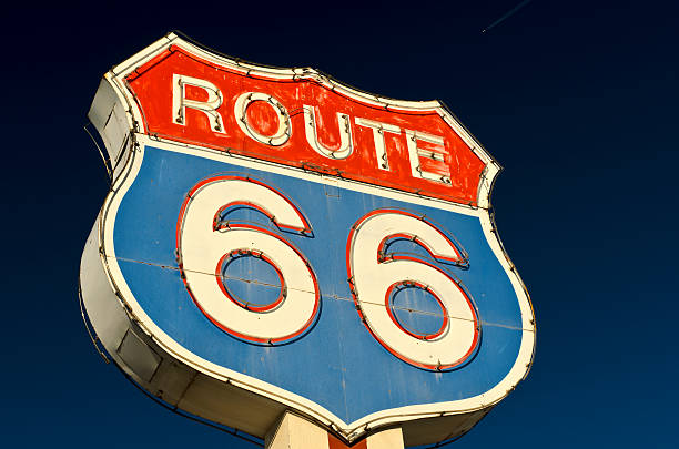 Route 66 Americana Red and Blue Neon Highway Sign Historic Route 66 Shield Shaped Neon Sign Along the old route roadside motel stock pictures, royalty-free photos & images