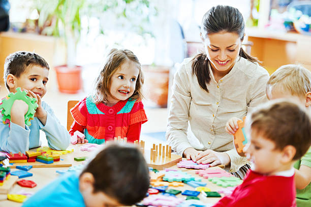 istock Nursery teacher playing with the kids 169941774