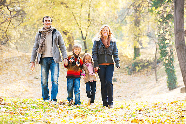 istock Cheerful family walking in park 169941798