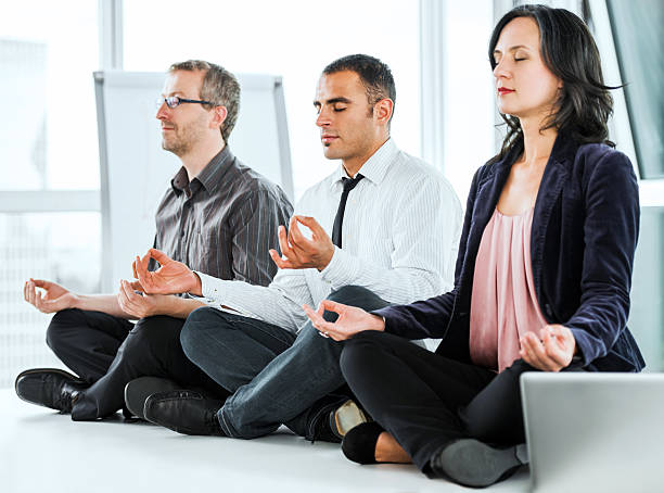 istock Successful businesspeople meditating in the office. 169941825