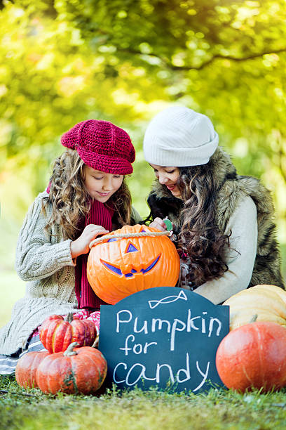istock Little girls with pumpkins 169942017