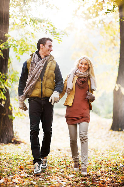 istock Beautiful smiling couple walking in the park. 169942159