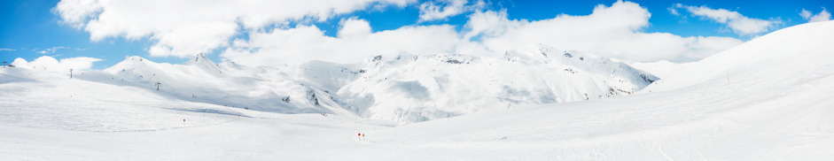 High mountain snowy  landscape. Livigno mountain range, Alps. It is located in the Italiy. Panorama made from multiple images.