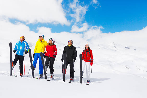 Skiing group on the mountain slope Group of skiiers with the instructor. Skiing class. Warming up and stretching. ski instructor stock pictures, royalty-free photos & images