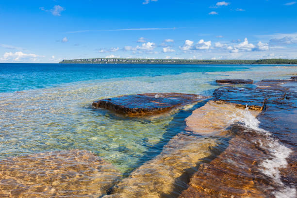 Turquoise-colored crystal clear waters of Georgian Bay with the Niagara Escarpment in the background, Ontario, Canada.