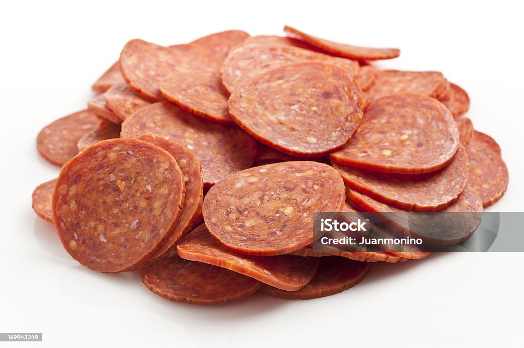 Heap of pepperoni Heap of pepperoni on white background Salami Stock Photo