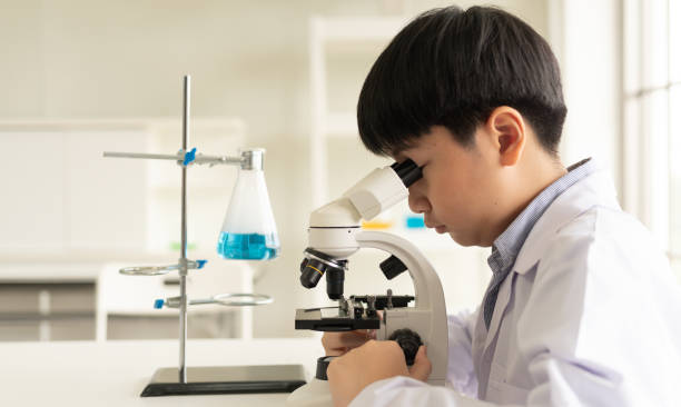 дети ученого изучают биологию и химию в лаборатории. концепция обучения stem-образованию. азиатский школьник использует микроскоп в лаборат� - chemistry chemistry class technician student стоковые фото и изображения