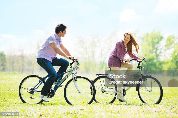 Bonito Casal Ciclismo No Parque - Fotografias de stock e mais imagens de Ciclismo - Ciclismo, Cor verde, Duas Pessoas