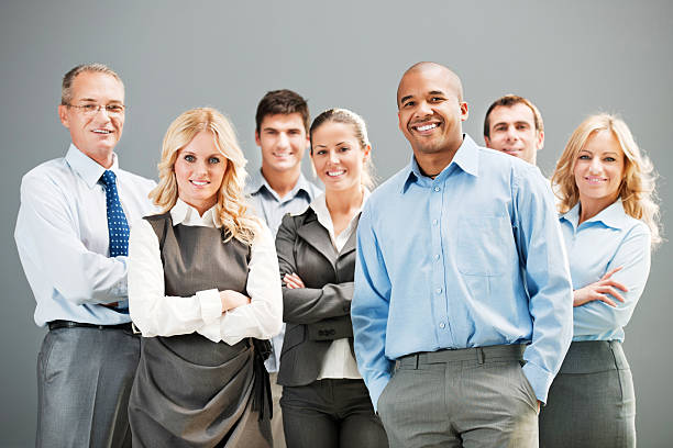 Mature successful business man with colleagues in office