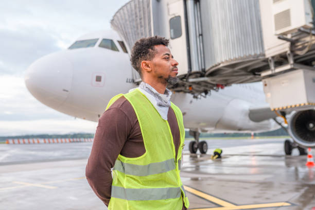istock Mixed Race Male Wearing A Reflective Vest While Working At The Airport 1699435510
