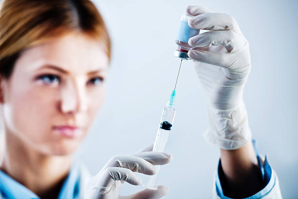 istock Female doctor preparing syringe. 169943557