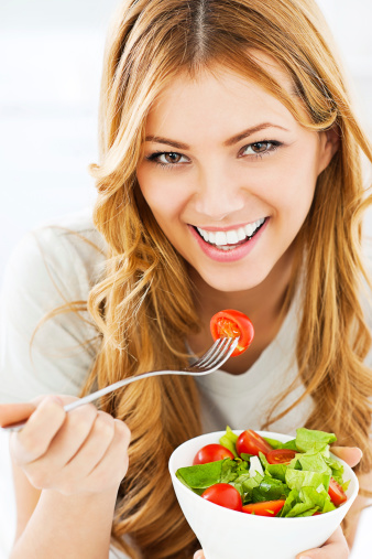 Young healthy woman with hamburger isolated