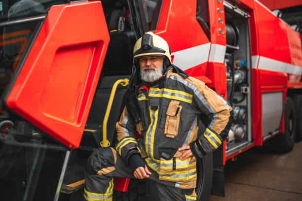 istock Firefighter Standing Next To A Fire Truck 1699436076