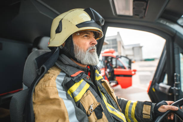 istock Senior Caucasian Firefighter Sitting In A Firetruck 1699436080