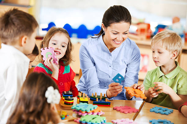 istock Nursery teacher playing with the kids. 169943704