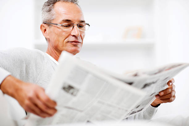 istock Mature man relaxing at home and reading newspaper. 169943748